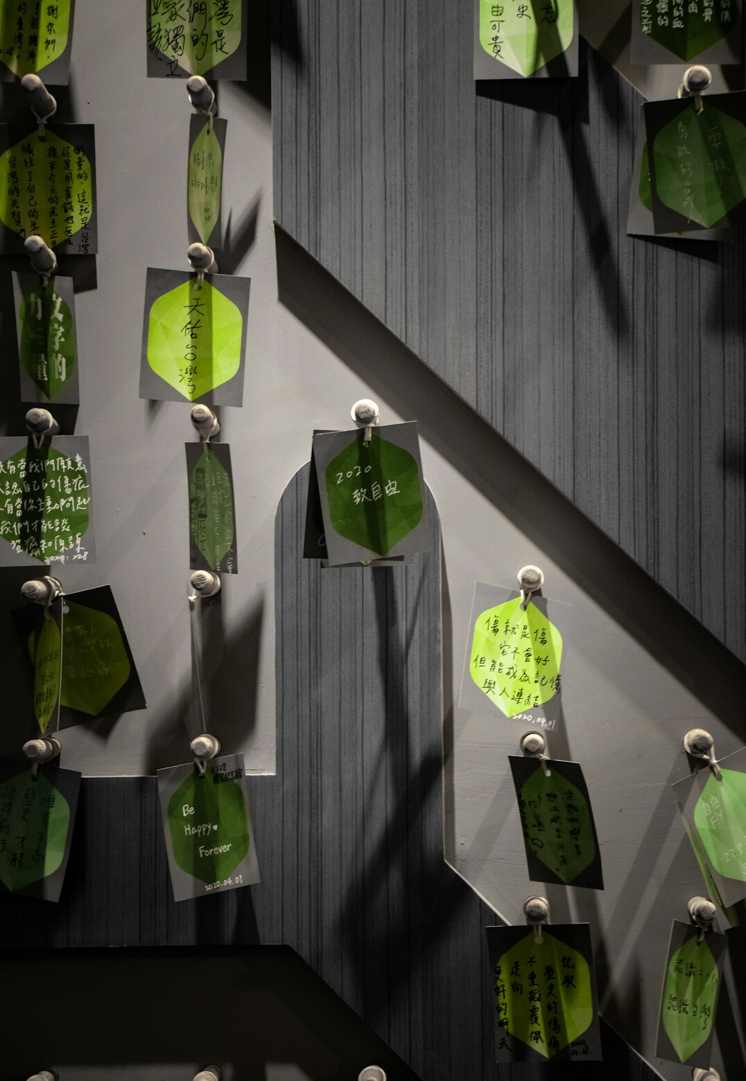 Group of employees brainstorming ideas with sticky notes on a glass wall
