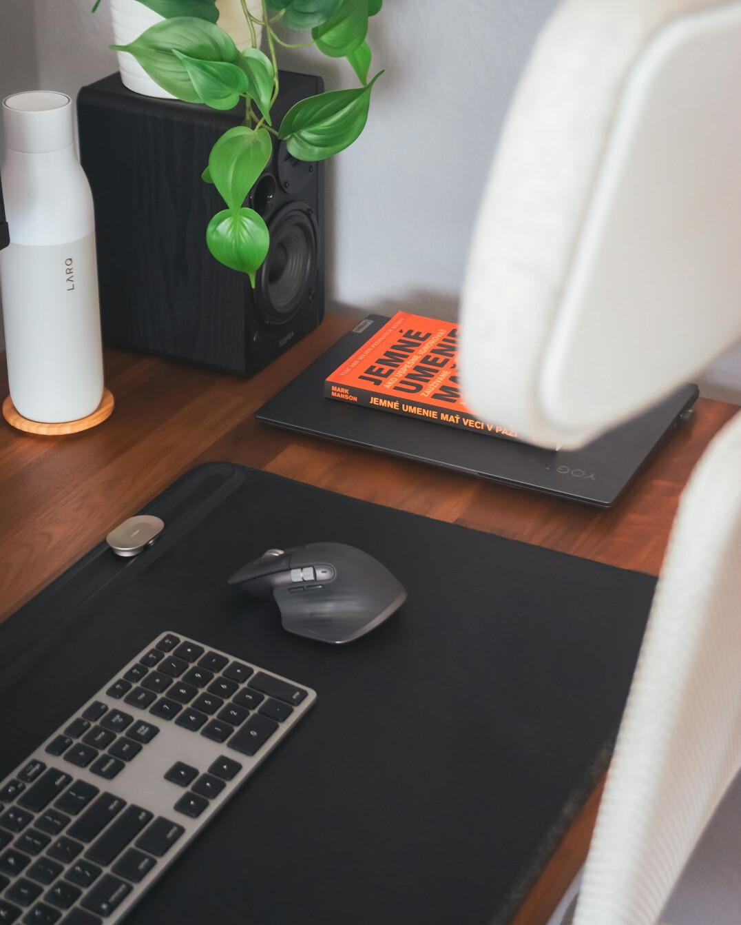 Organized desk with laptop, notebook and coffee cup